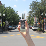 Hand holding the Franklin room spray on Main Street in downtown Franklin, Tennessee