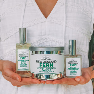 Woman holding the New Zealand Fern candle, cologne and room spray