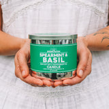 Hands holding the Spearmint & Basil 100% soy wax candle