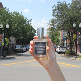 Hand holding the Franklin cologne on Main Street in downtown Franklin, Tennessee