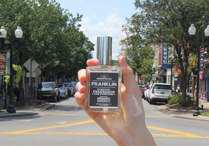 Hand holding the Franklin cologne on Main Street in downtown Franklin, Tennessee