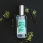 Vanilla Matcha room spray with matcha powder and vanilla beans on a black background