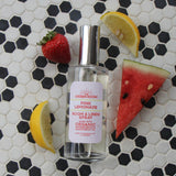 Pink Lemonade room spray on black and white hexagon tile with watermelon, strawberry and lemon