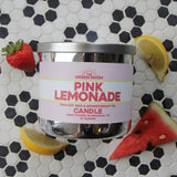 Pink Lemonade candle on black and white hexagon tile with watermelon, strawberries and lemon