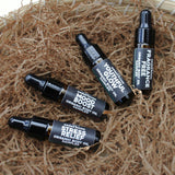 The Green Room 4 PC Body Oil Sampler Collection: four 5 ml amber dropper vials, Youthful Glow, Mood Boost, Stress Relief and Fragrance Free, lined up on a wood slab outside the shop on Main Street in Franklin, TN.